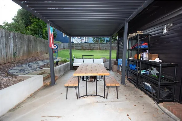 a swimming pool with outdoor seating and yard
