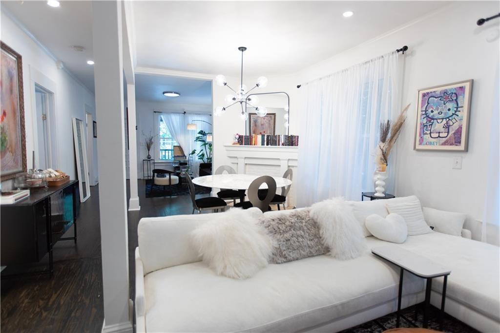 938 Ormewood Avenue Southeast Atlanta, GA 30316 - Photo 5 of 21 a living room with furniture a fireplace and a chandelier
