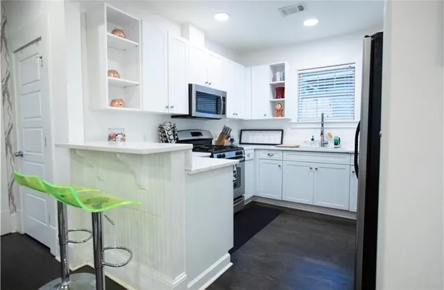 a kitchen with a sink a cabinets and window