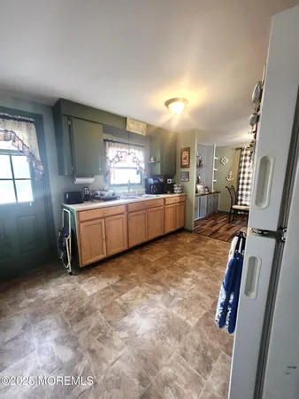 a large bathroom with a tub sink and mirror