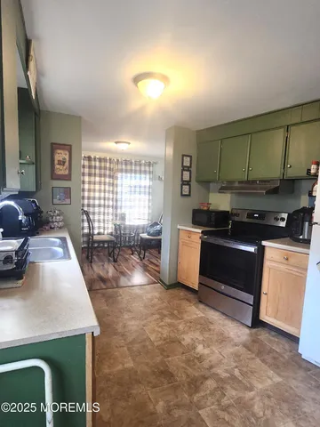 a kitchen with stainless steel appliances a sink a stove and a refrigerator
