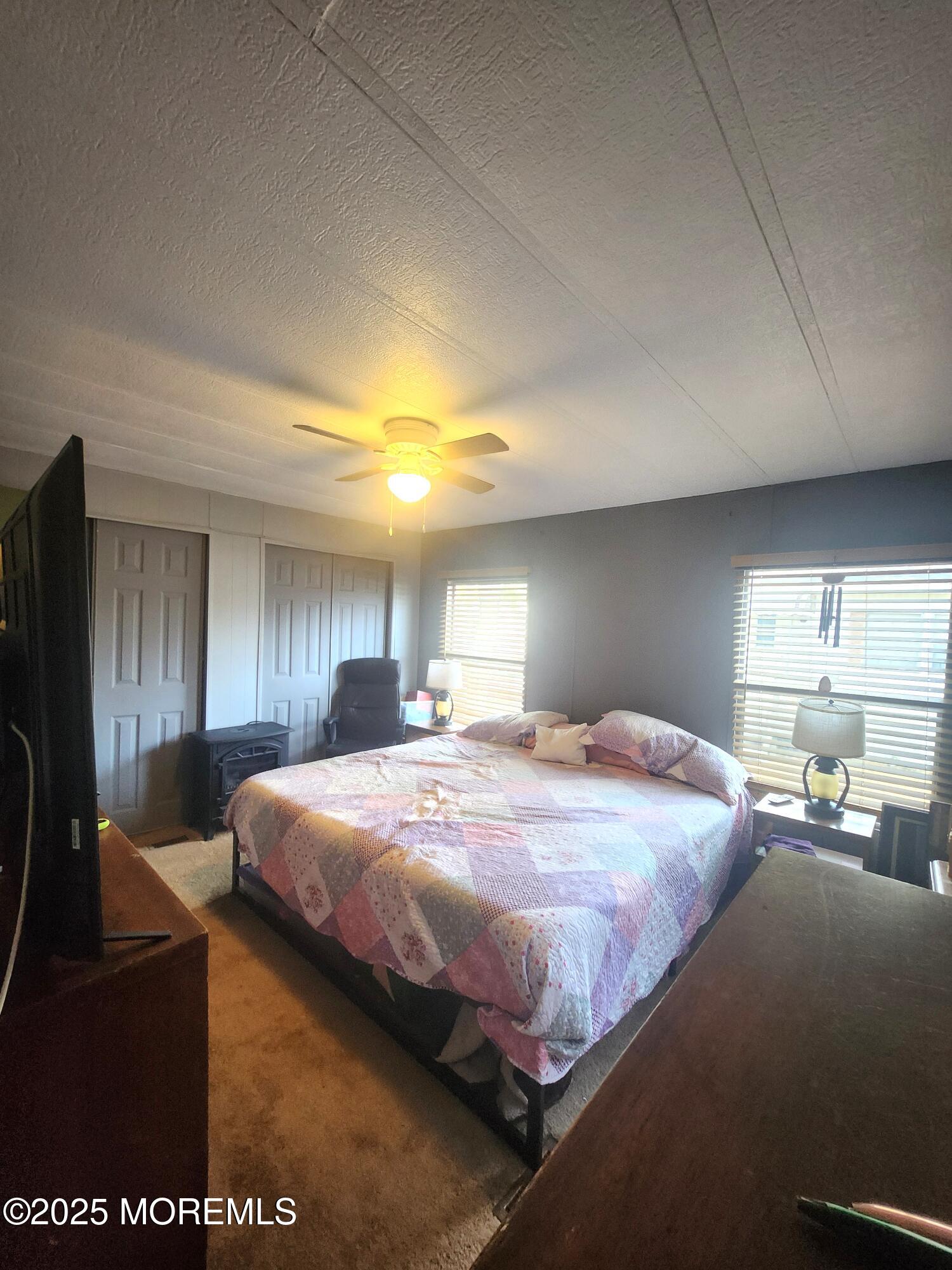 165 Mockingbird Way Manchester Township, NJ 08759 - Photo 15 of 20 a bedroom with a bed mirror and window