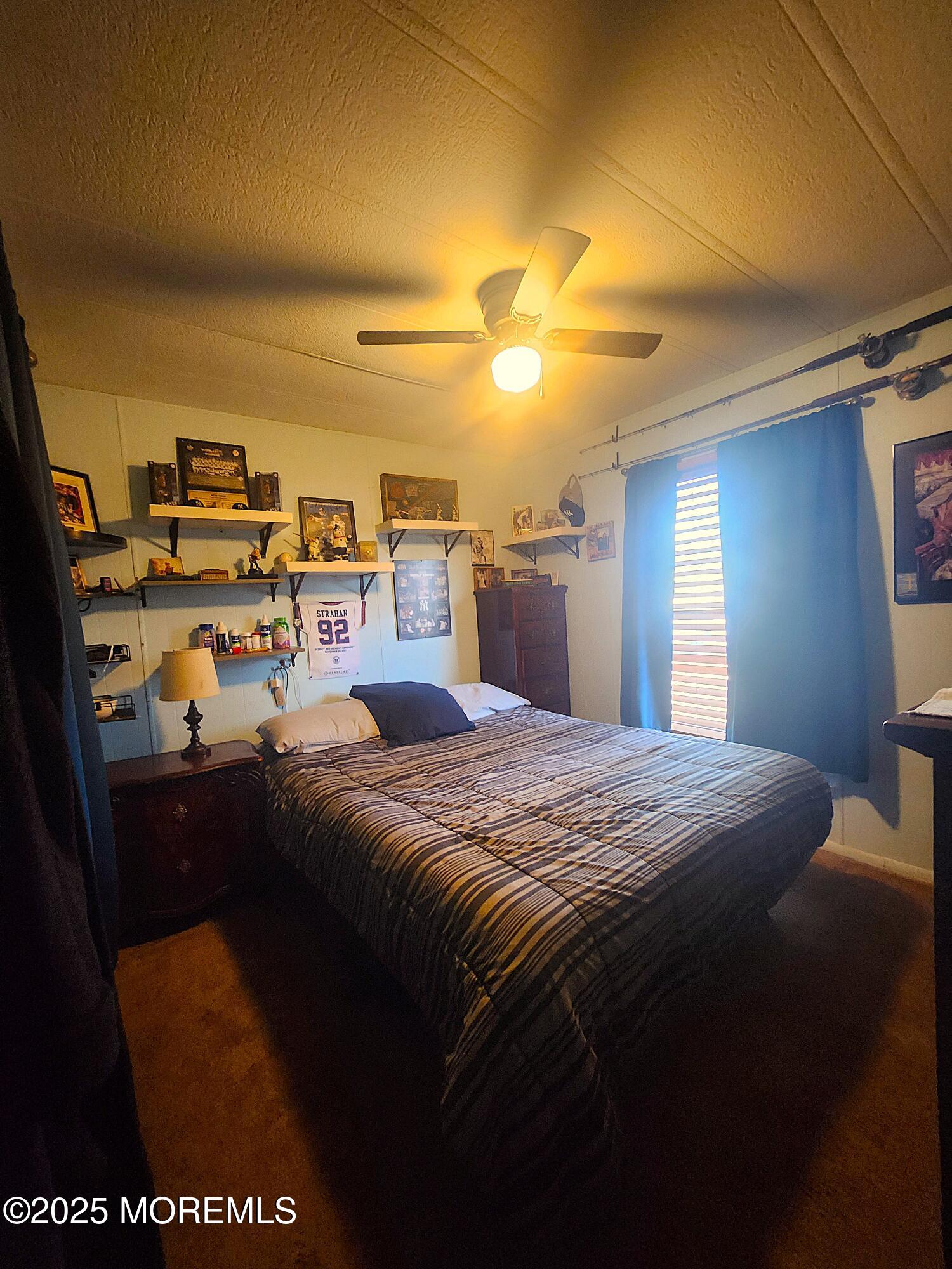165 Mockingbird Way Manchester Township, NJ 08759 - Photo 17 of 20 a bedroom with a bed and a view of kitchen