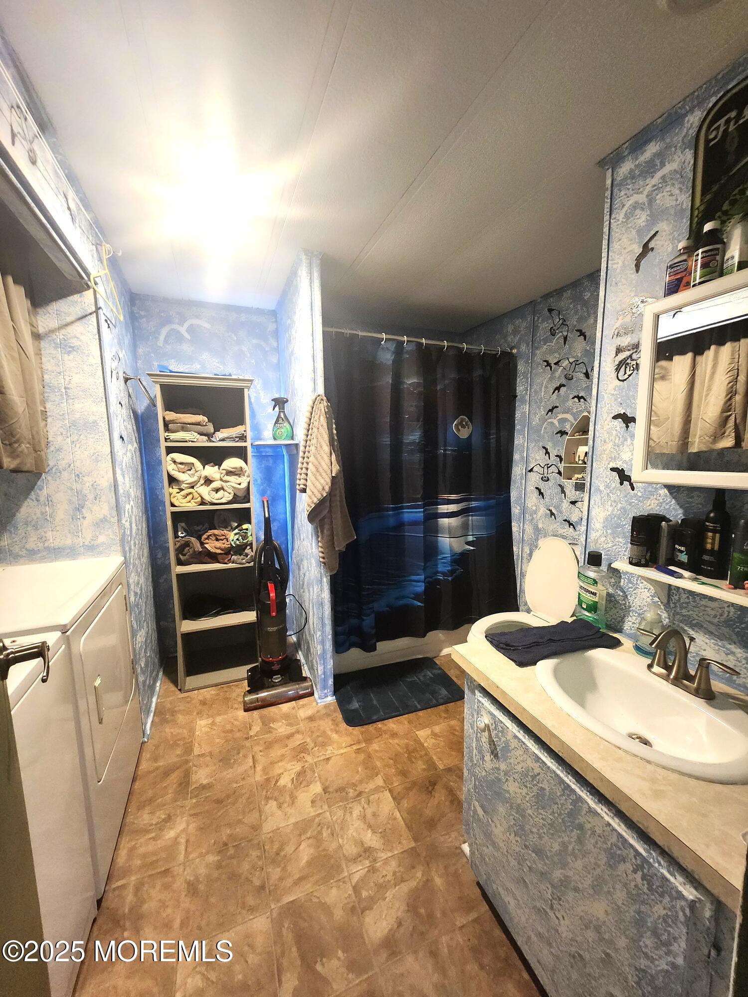 165 Mockingbird Way Manchester Township, NJ 08759 - Photo 18 of 20 a bathroom with a sink a vanity and a mirror