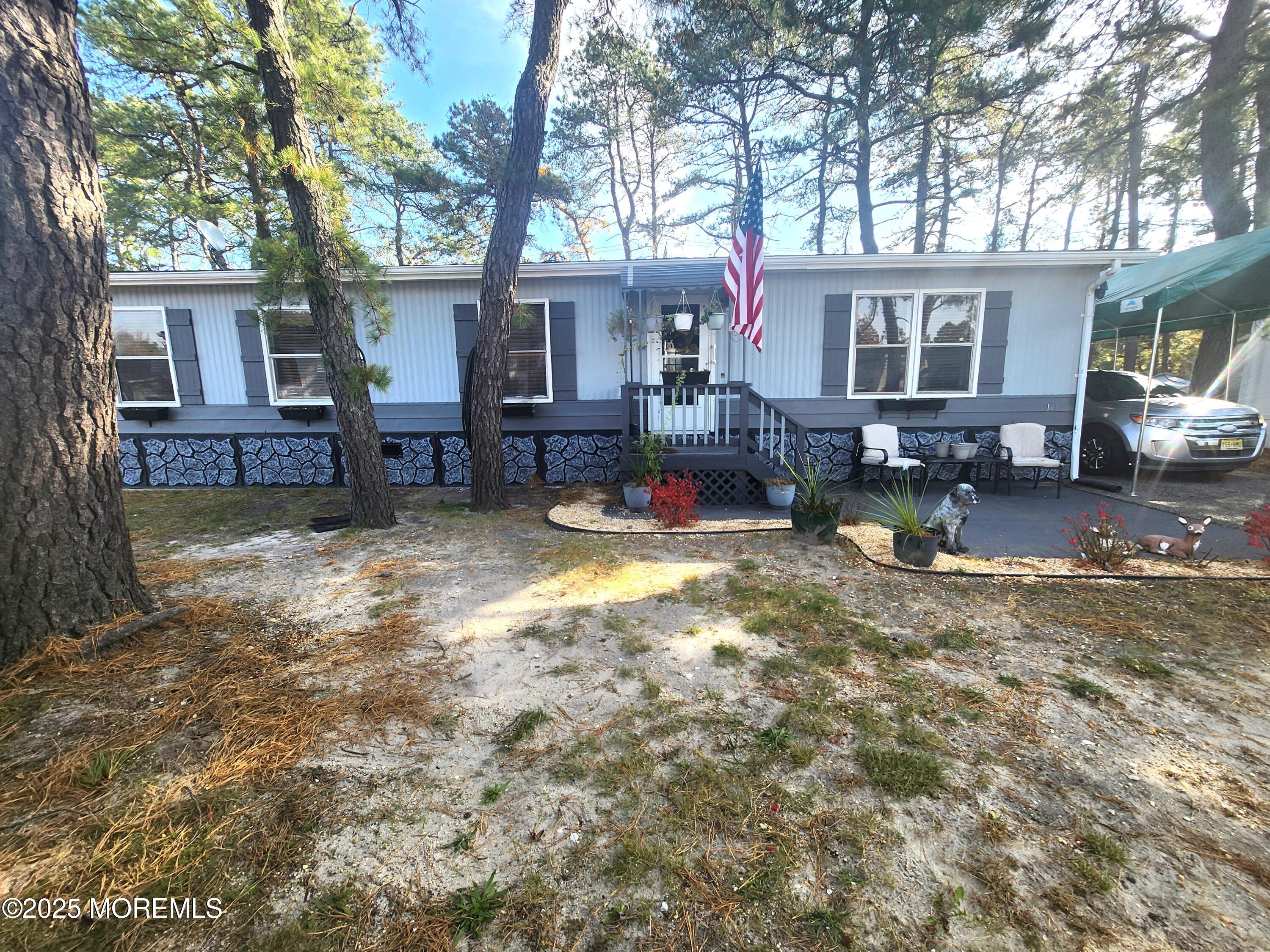 165 Mockingbird Way Manchester Township, NJ 08759 - Photo 4 of 20 a view of a house with a yard covered in snow