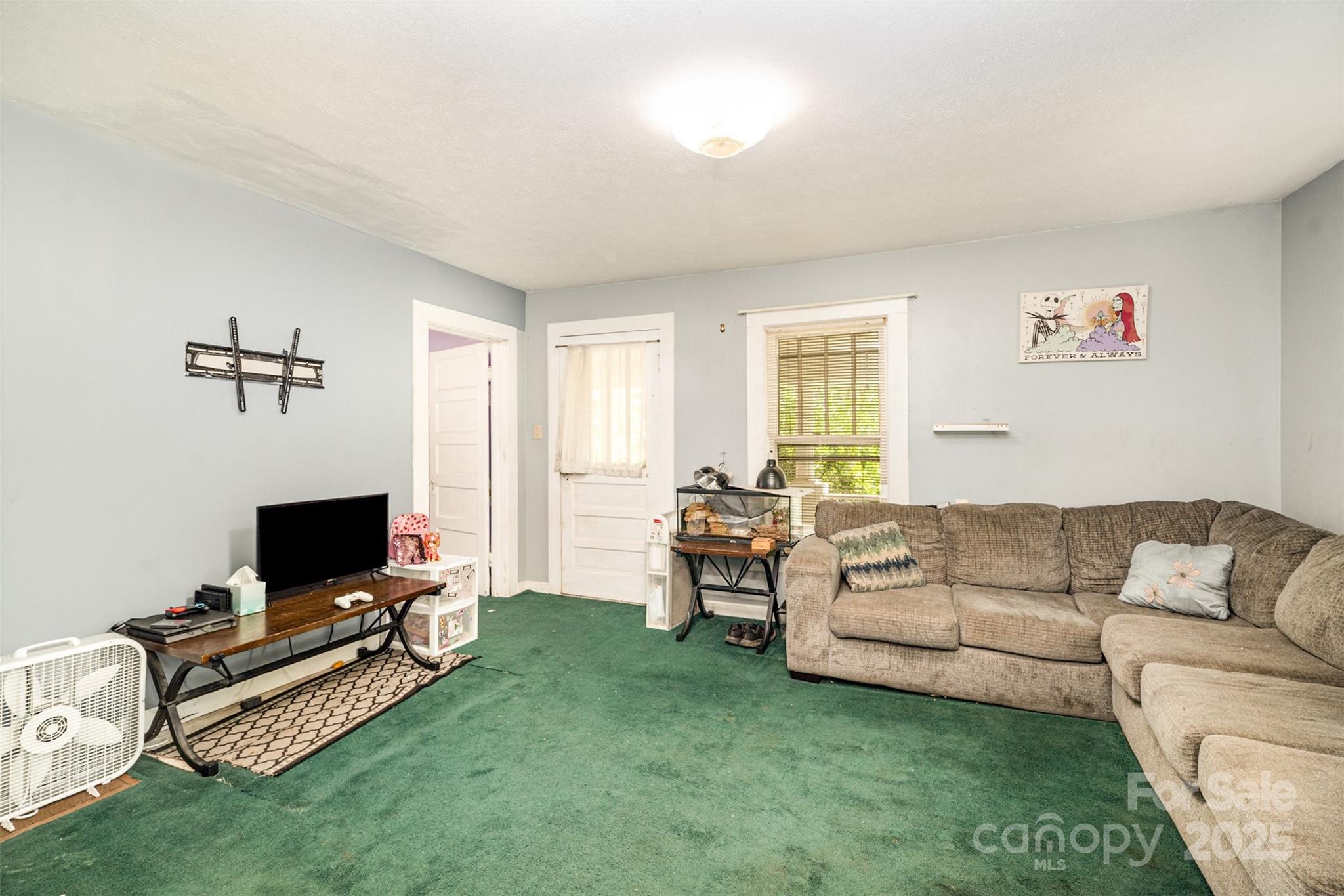 1245 Harrison Loop Morganton, NC 28655 - Photo 3 of 20 a living room with furniture and a flat screen tv