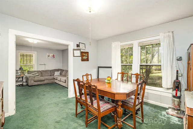 a view of a dining room with furniture and a large window