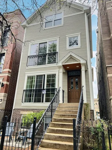 a view of a brick house with large windows