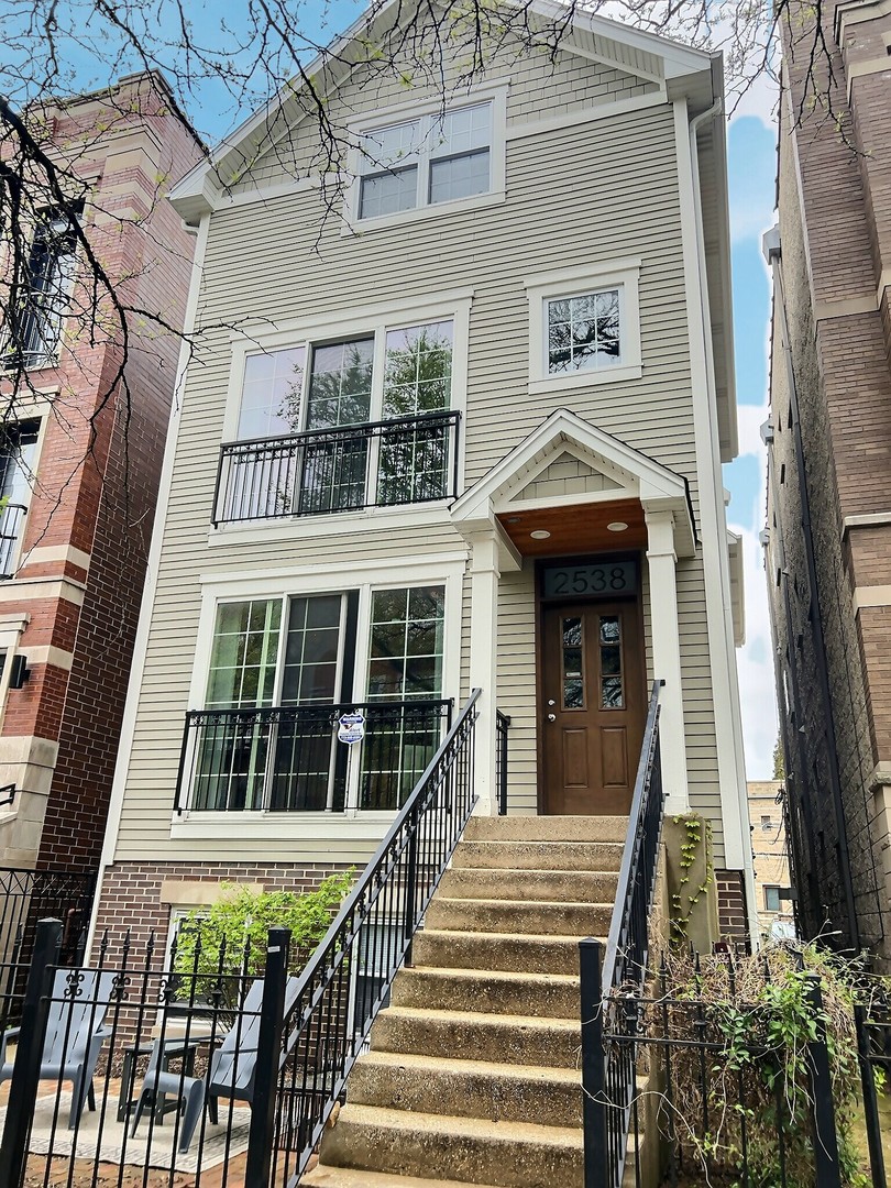 a view of a brick house with large windows