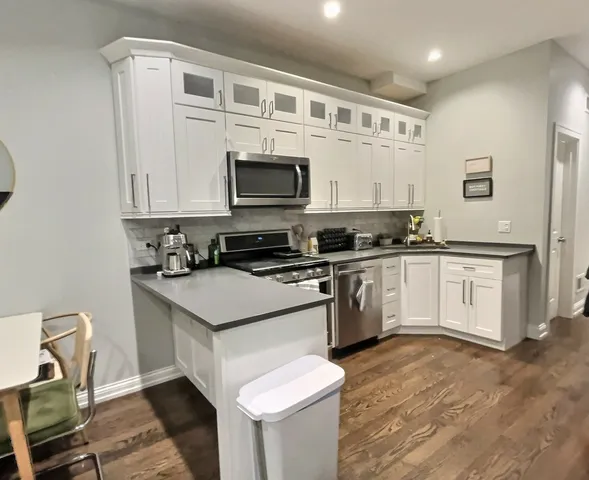 a kitchen with a sink stove and microwave