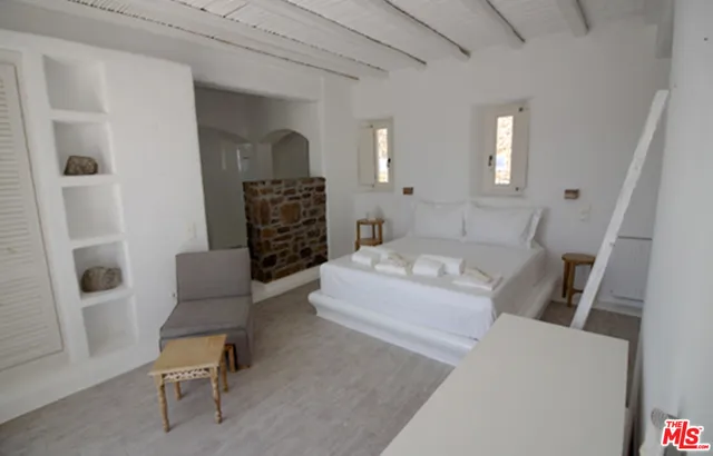 a spacious bedroom with a bed and a fireplace