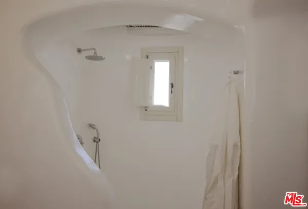 a spacious bedroom with a bed and a window