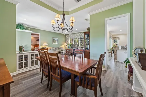 a view of a dining room with furniture wooden floor and chandelier