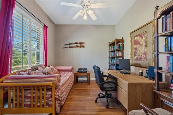 a bed sitting in a bedroom next to a window