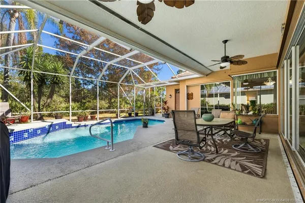 a view of a patio with a table and chairs