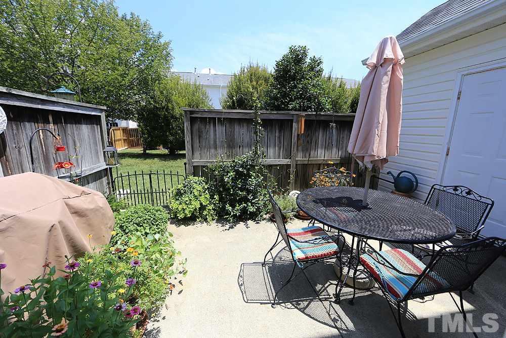 2041 Rivergate Road, Unit 103 Raleigh, NC 27614 - Photo 16 of 21 Gorgeous private patio with lush perennial plantings and wooded buffer. Gas grill and patio set are negotiable!