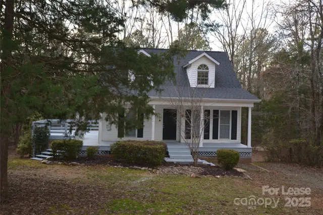 a front view of a house with a yard garage and outdoor seating