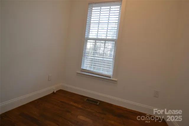 wooden floor and window in an empty room