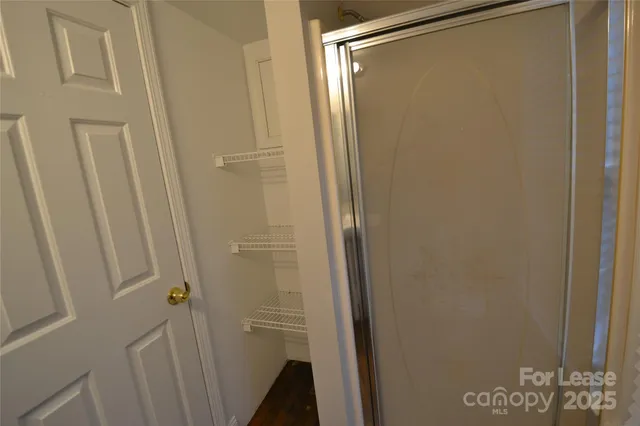 a bathroom with a glass shower door