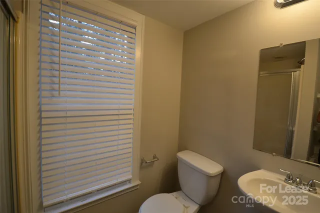 a white toilet sitting next to a bathroom sink