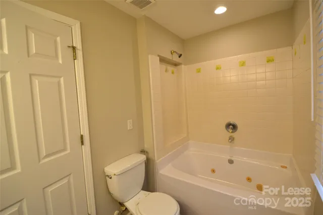 a bathroom with a toilet and a bathtub