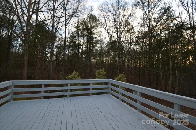 a view of backyard with hardwood and deck