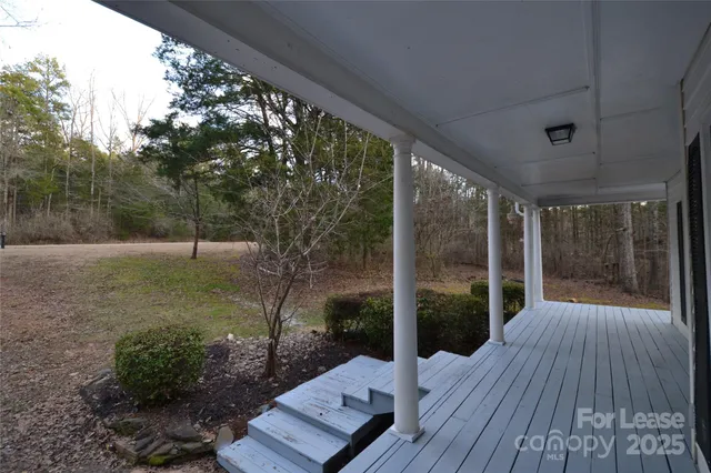 a view of backyard with plants and outdoor seating