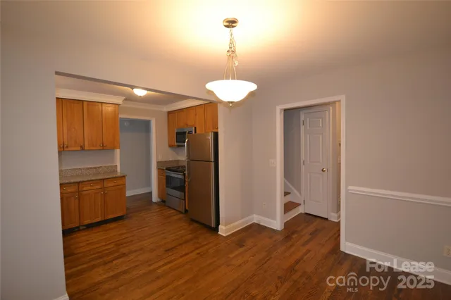 a kitchen with stainless steel appliances granite countertop a refrigerator and a sink