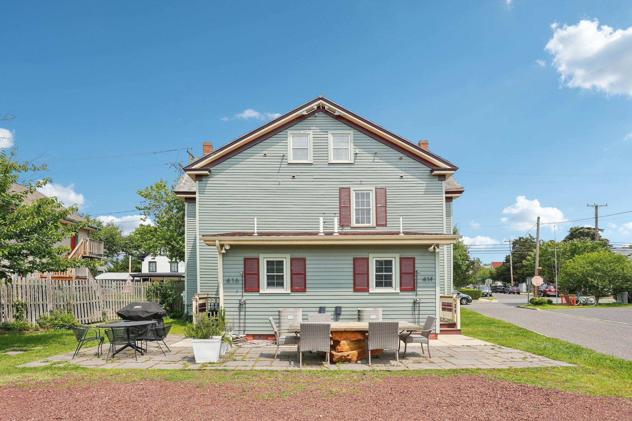 414 Broadway, Unit 414 West Cape May, NJ 08204 - Photo 16 of 48 a front view of a house with a yard outdoor seating and covered with trees