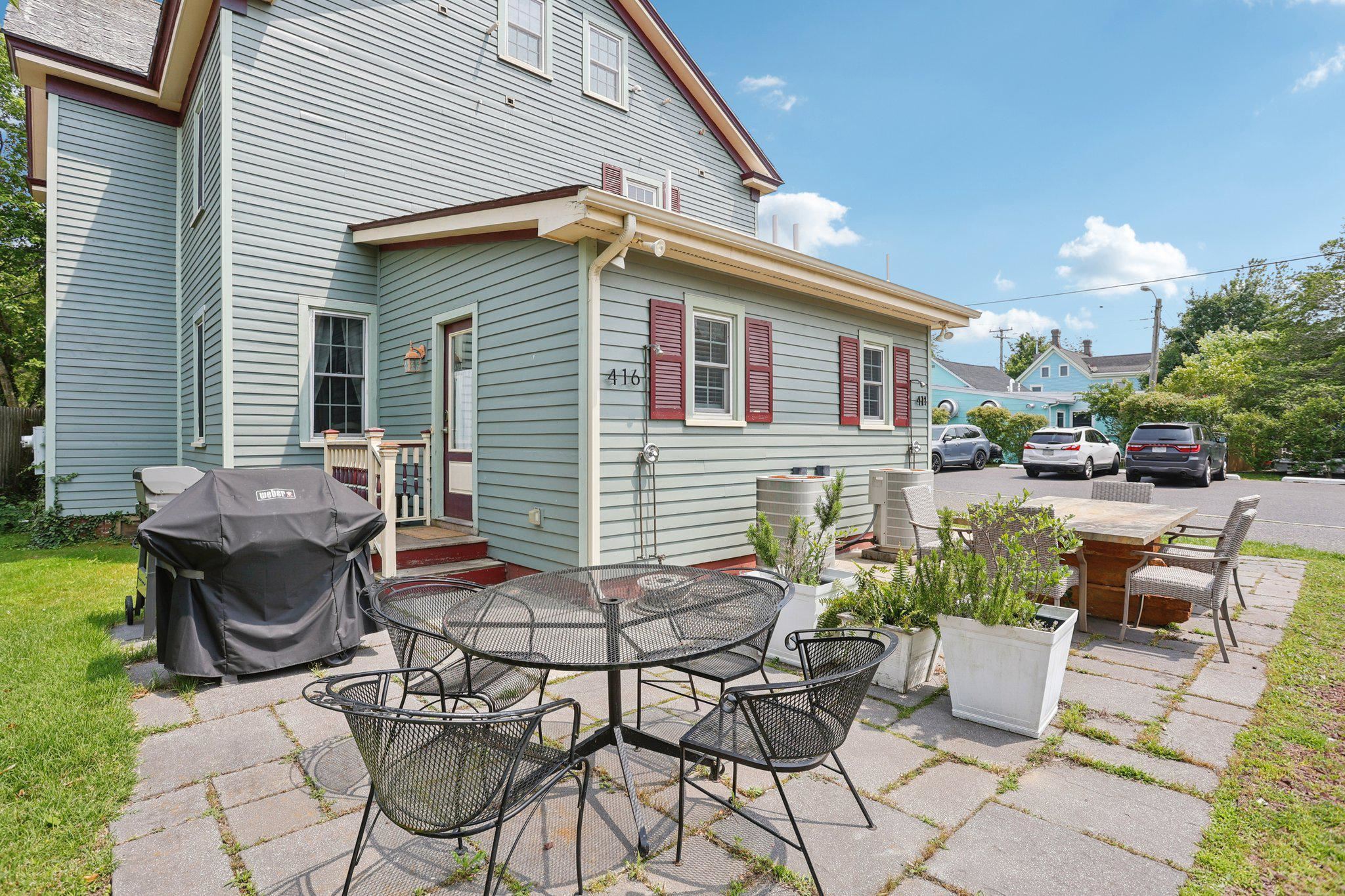 414 Broadway, Unit 414 West Cape May, NJ 08204 - Photo 19 of 48 a backyard of a house with table and chairs