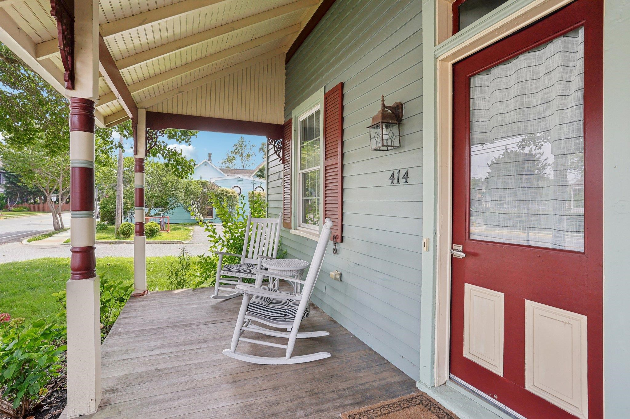 414 Broadway, Unit 414 West Cape May, NJ 08204 - Photo 24 of 48 a chair and table in front of a building