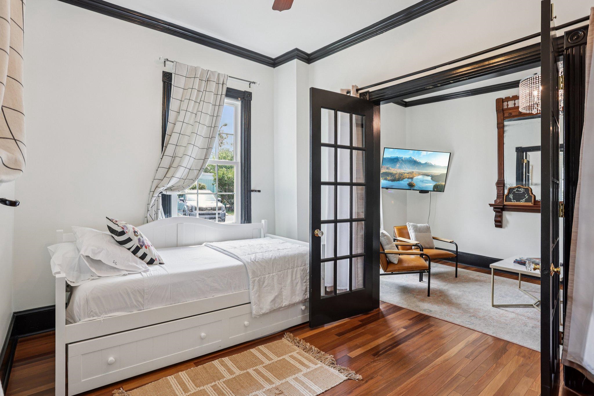 414 Broadway, Unit 414 West Cape May, NJ 08204 - Photo 30 of 48 a bedroom with a bed and wooden floor