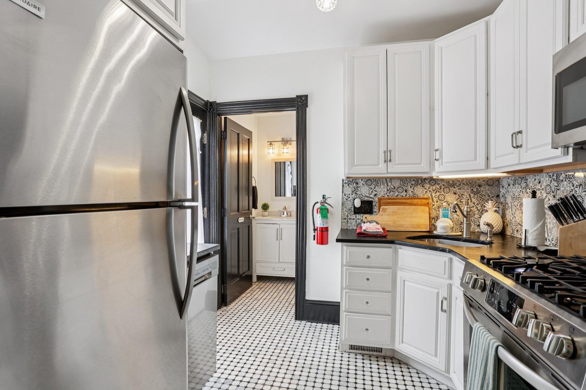 414 Broadway, Unit 414 West Cape May, NJ 08204 - Photo 34 of 48 a kitchen with stainless steel appliances a refrigerator and a stove top oven