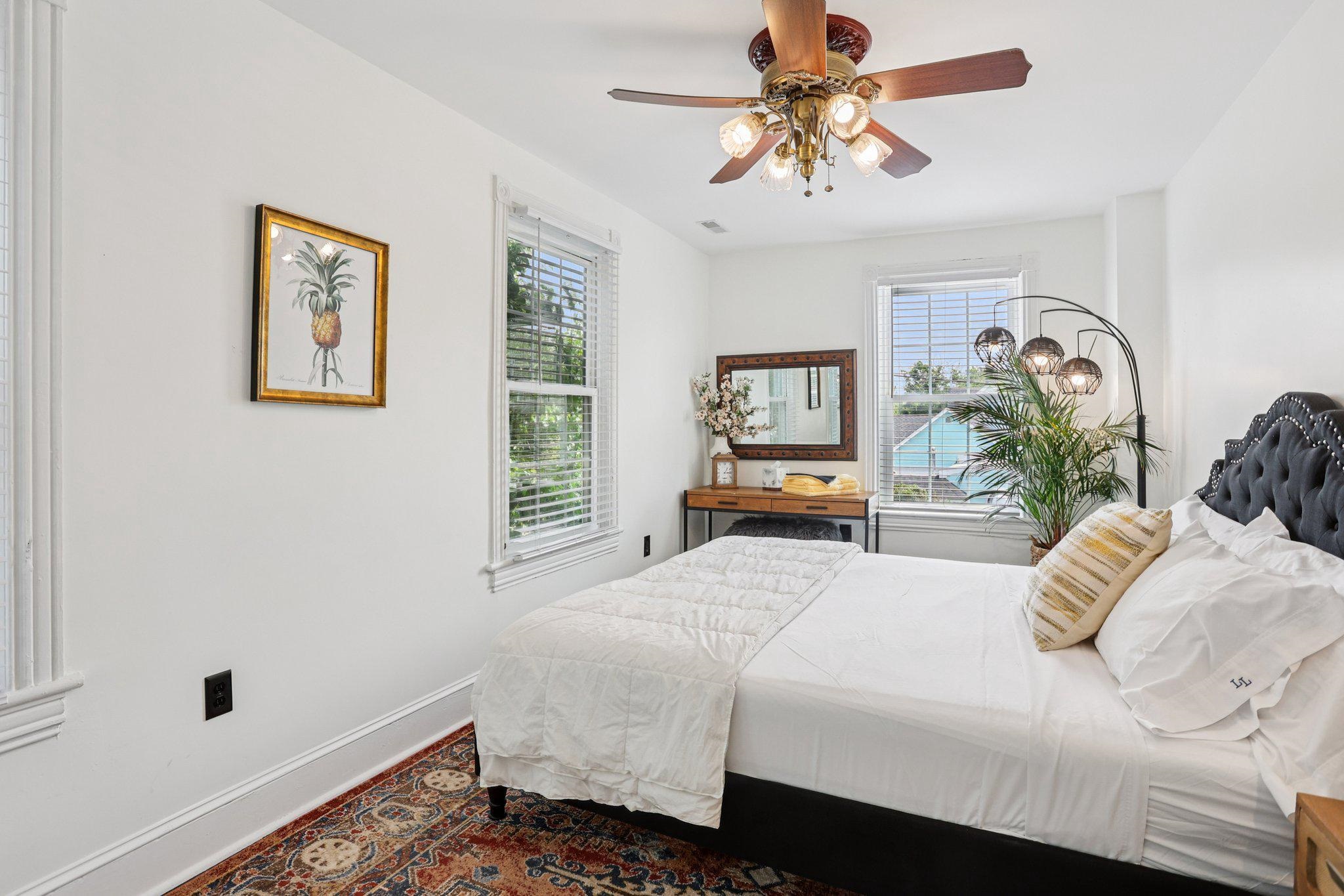 414 Broadway, Unit 414 West Cape May, NJ 08204 - Photo 41 of 48 a bedroom with a bed and a chandelier