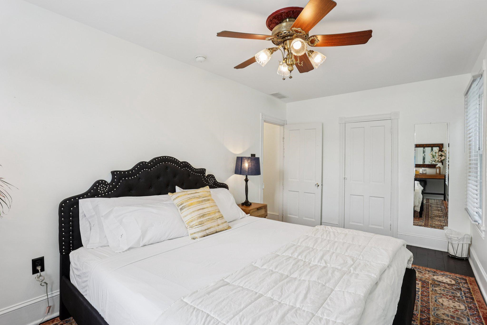 414 Broadway, Unit 414 West Cape May, NJ 08204 - Photo 43 of 48 a bedroom with a bed and a chandelier