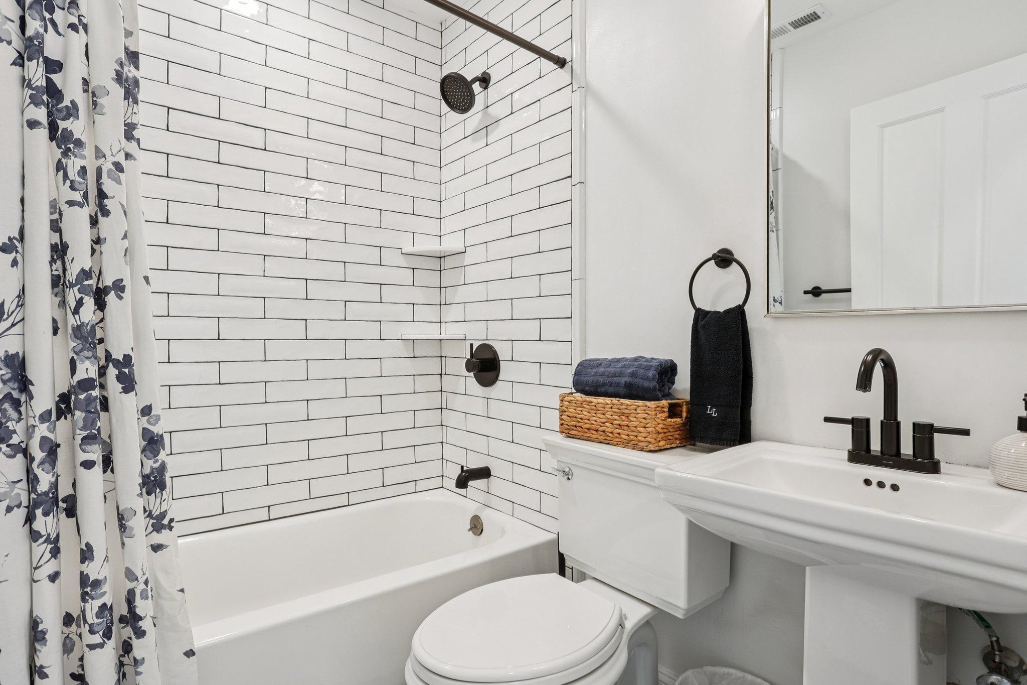 414 Broadway, Unit 414 West Cape May, NJ 08204 - Photo 44 of 48 a bathroom with a sink toilet and shower