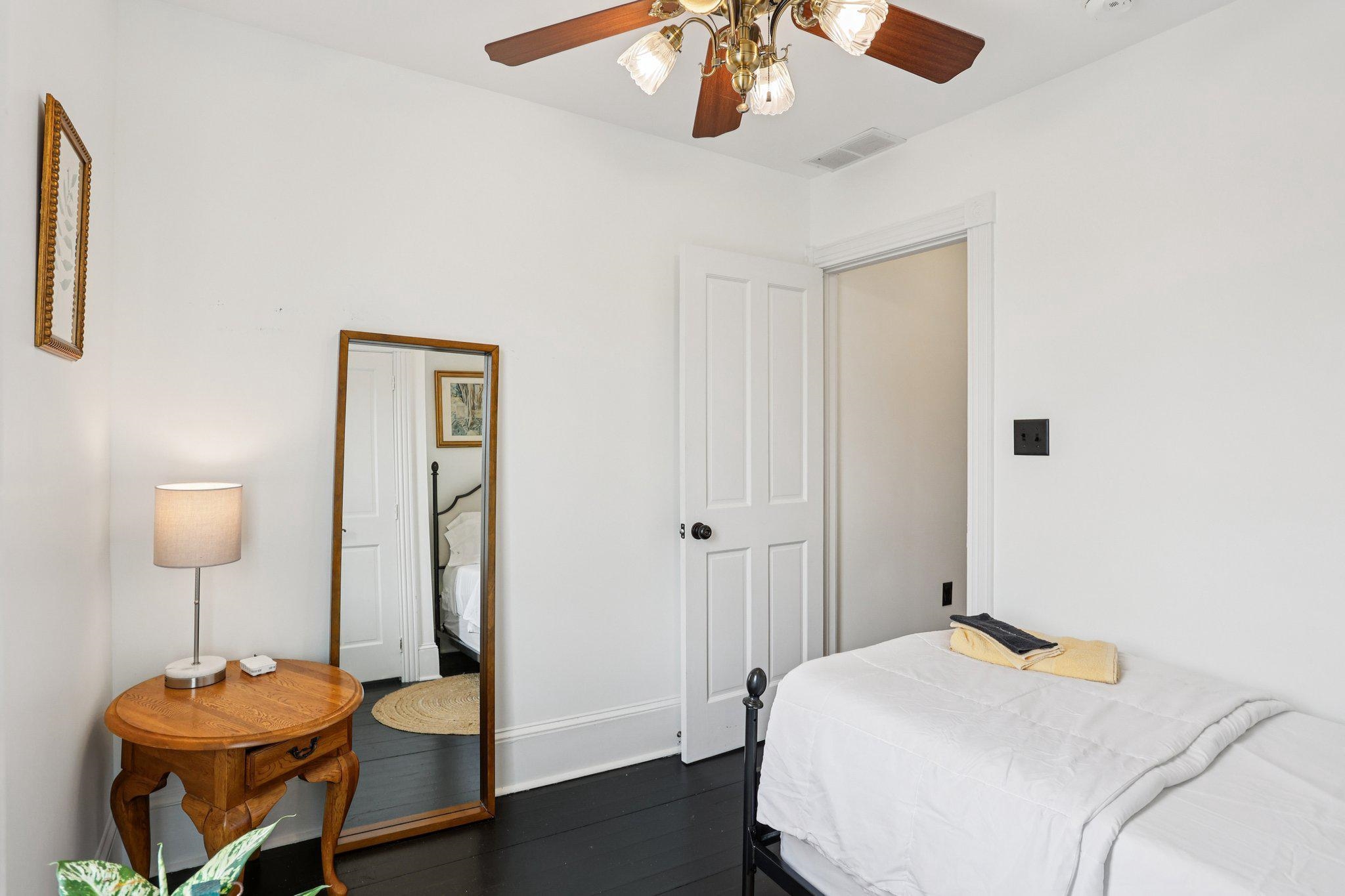 414 Broadway, Unit 414 West Cape May, NJ 08204 - Photo 48 of 48 a bedroom with a bed and a chandelier