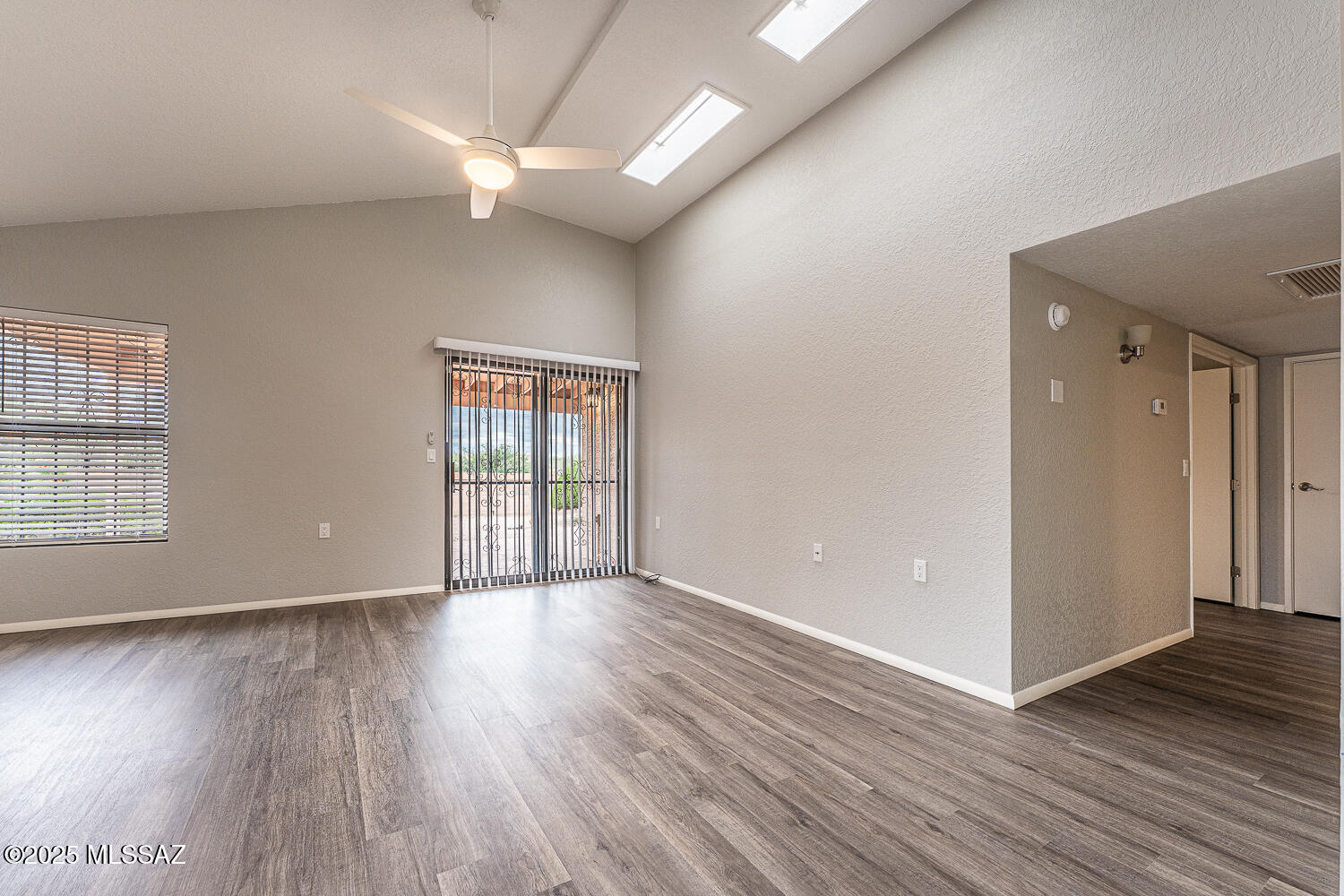 931 West Rio Guaymas Green Valley, AZ 85614 - Photo 17 of 39 a view of an empty room with wooden floor and a window