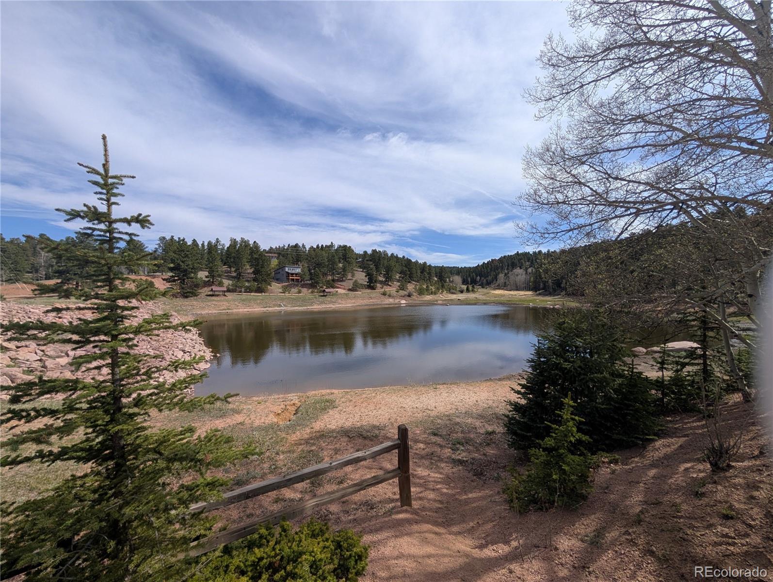 971 Spring Valley Lane Florissant, CO 80816 - Photo 8 of 14 a view of a lake with a building in the background