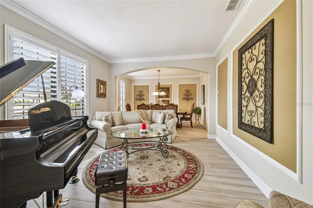 a bedroom with a large bed a rug and a window