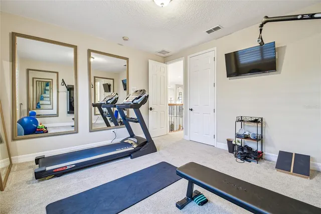a room with pool table and windows