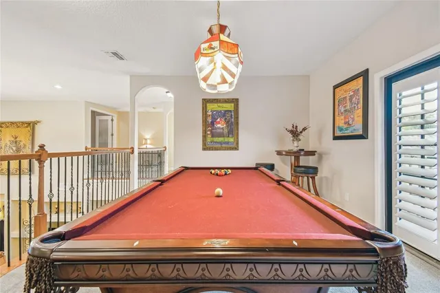 a living room with furniture a flat screen tv and kitchen view