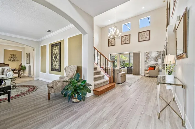 a living room with furniture and a chandelier