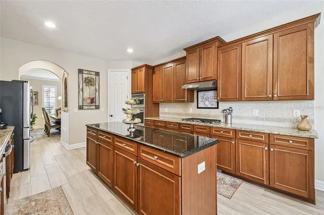 a kitchen with granite countertop cabinets and a wooden floor