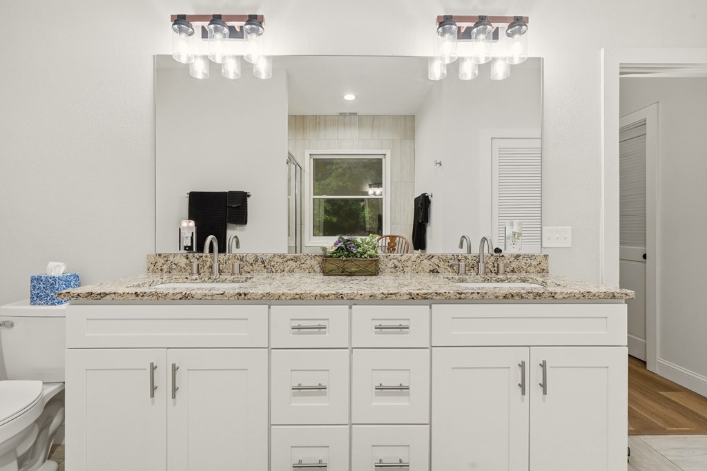 175 Crane Creek Road Young Harris, GA 30582 - Photo 21 of 40 a bathroom with a sink vanity and a mirror