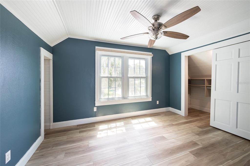 922 Delaware Avenue St. Cloud, FL 34769 - Photo 15 of 31 a view of empty room with wooden floor and fan