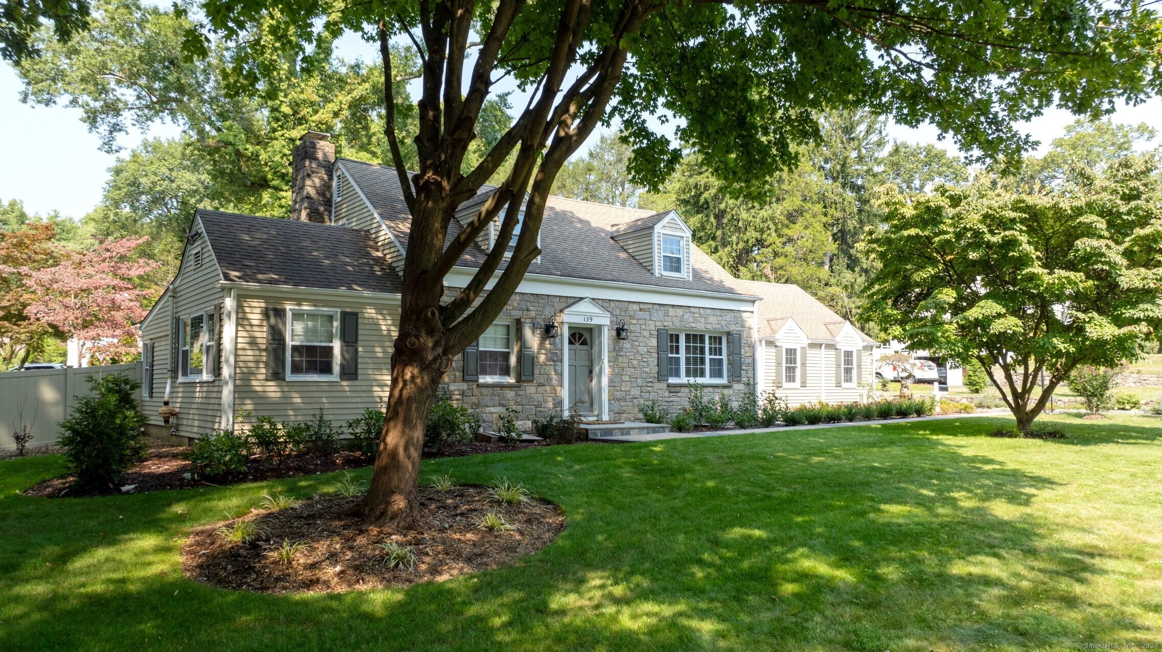 a front view of house with yard and green space
