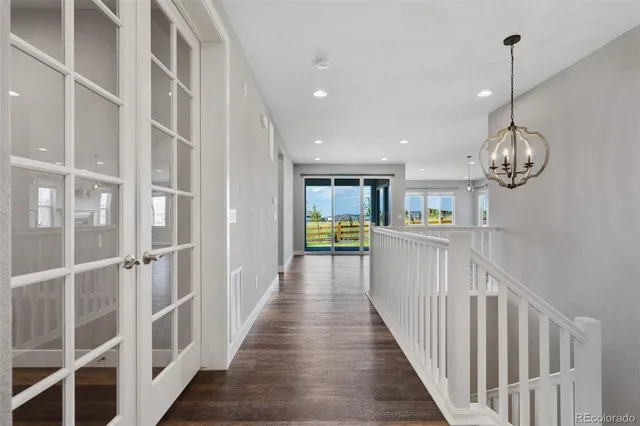 a view of a hallway with wooden floor and entryway