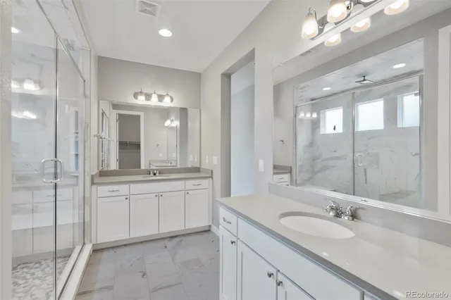 a bathroom with a granite countertop sink mirror and double