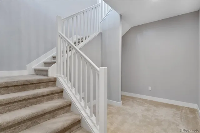 a view of staircase with lots of frames on wall